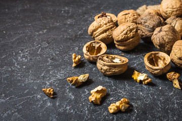 Walnut kernels on a dark stone background