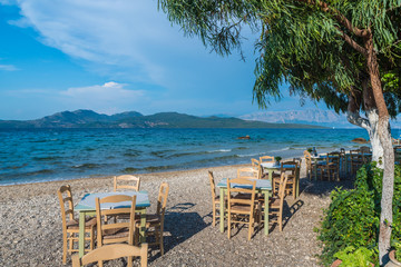 Taverna with table and chairs on Nikiana beach, Lefkada island, Greece - obrazy, fototapety, plakaty