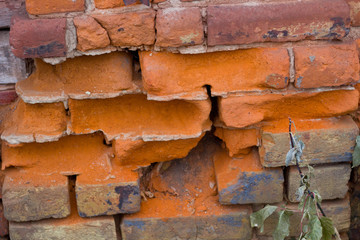 Semi broken brick wall on the house. The background
