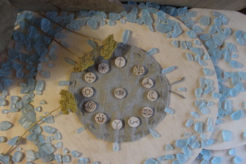 Wooden handmade witch runes with a linen pouch, blue cristals and yellow flowers in a rustic style