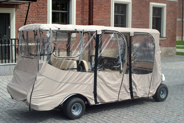 Six-seater Golf cart with rain protection. Wagon for tourists.