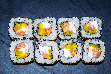 Sushi Set nigiri and sushi rolls on gray stone slate on metal background