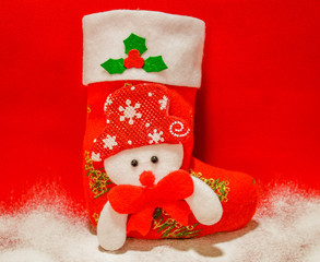Christmas sock and snow on a red background