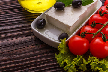 A piece of feta cheese on a wooden rustic background