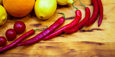Tomatoes with herbs and spices, ingredient for tomato sauce on blue wooden background, frame, top view