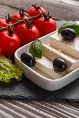 A piece of feta cheese on a wooden rustic background