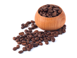 Roasted coffee beans in wooden cup on a white background