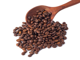 Roasted coffee beans on a wooden spoon on a white background