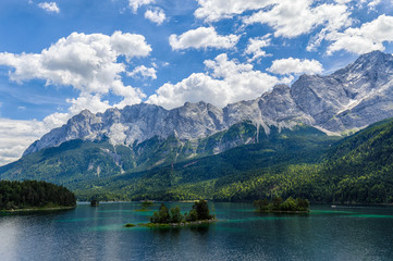 Small islands on the Eibsee, Wetterstein mountains with Zugspitze and Waxenstein in the background.