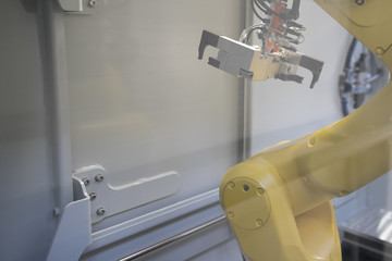 Naklejka premium Industrial robotic welding, robot gripping and robotic 3D scan working with auto parts on smart factory, on machine blue tone color background, industry 4.0 and technology, concept and idea
