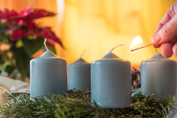 Light a candle with a match - Advent wreath
