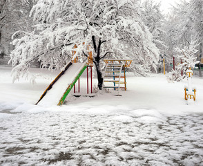 Snow-covered attractions in the old park