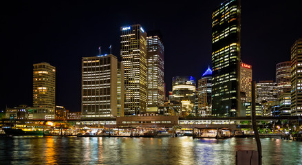 Fototapeta na wymiar Circular quay and ferry terminal at night with city lights in Sydney, Australia on 2 October 2013