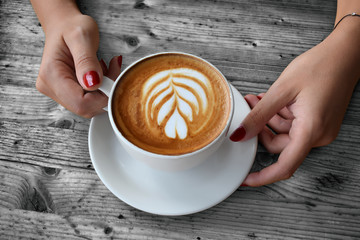 Woman enjoying coffee on a wooden table