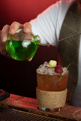 Professional barman mixes cocktails