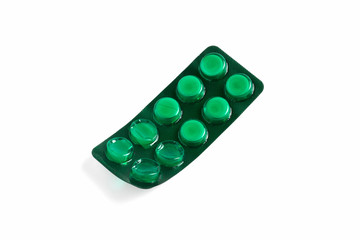 Green blister with pills isolated on white background. Health and medicine. for design and decoration. several tablets used to treat a patient