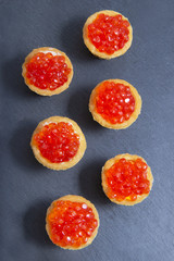 Naklejka na ściany i meble Tartlets with red caviar. Selective focus, space for text . serve red caviar top view