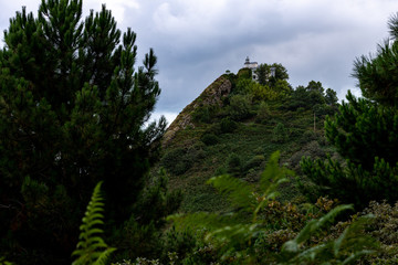 Fototapeta premium lighthouse atop a cliff at the steep coast