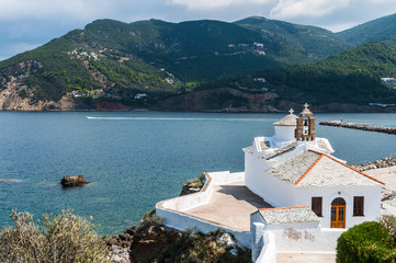 The church of the Virgin Mary (Panagitsa Tower) with stone tile on Skopelos city on backgroud of...