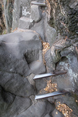 Metal spurts in the rock like steps of the stairs.