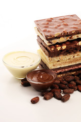 Chocolate bars on table with chocolate tower.