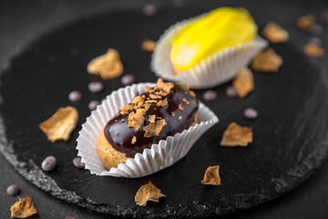 Cake eclair with custard, almonds, chocolate. Assortment of confectionery.