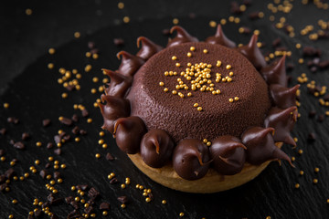 Delicate biscuit cake with chocolate. Assortment of confectionery.