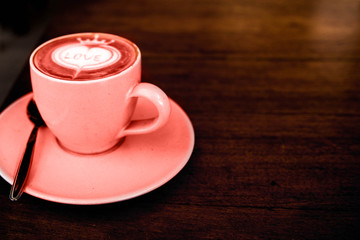 Cup of cappuccino is on the wooden texture table