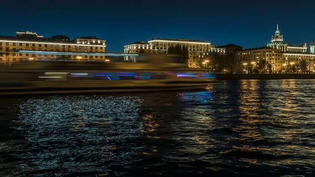 view of illuminated night river , embankment and the movement of river vessels