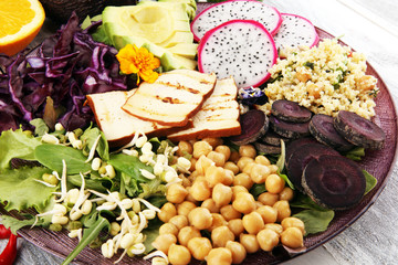 grilled tofu and dragon fruit buddha bowl with vegetable and humus