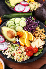 grilled tofu and dragon fruit buddha bowl with vegetable and humus