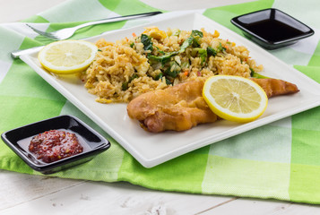 Fried cod with lemon, fried rice, vegetables, sambal and soy sauce