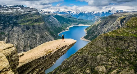 Fototapete Rund Amazing nature view with Trolltunga and a girl standing  on it. Location: Scandinavian Mountains, Norway, Stavanger. Artistic picture. Beauty world. The feeling of complete freedom © olenatur