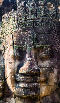 Stone murals and statue Bayon Temple Angkor Thom. Angkor Wat the largest religious monument in the world. Ancient Khmer architecture. Location: Siem Reap, Cambodia.