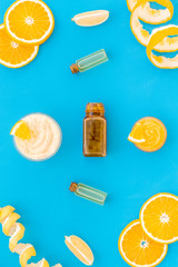 citrus orange cosmetic for natural spa bath on blue table background top view mock up