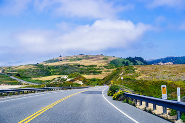 Driving on the scenic Highway 1 (Cabrillo Highway) on the Pacific Ocean coastline close to...