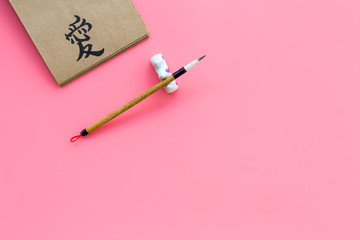 Chinese traditional calligraphy concept. Asian hieroglyph love in craft paper notebook near special...