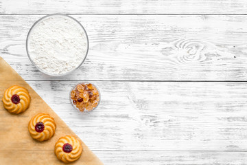Ingredients for homemade cookies. Fresh cookies near flour on white wooden background top view copy space