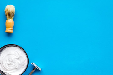 Instruments of male hairdresser barbershop top view on blue background mockup