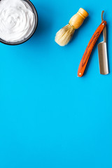 barbershop desk with tools for male care blue background top view mock-up