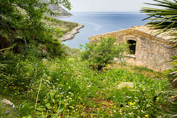 Typical Sicilian house overlooking Mediterranean Sea at Zingaro Nature Reserve, San Vito Lo Capo, Sicily, Italy