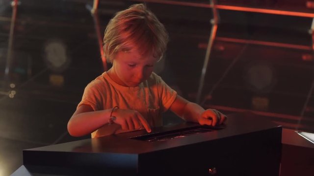 Little boy uses a table pc with an astronomical zodiak map. Children education concept.