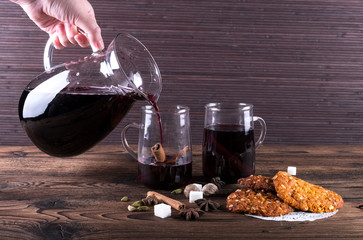 Decorated composition of mulled wine in glasses on wooden table