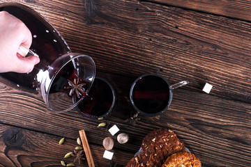 Decorated composition of mulled wine in glasses on wooden table