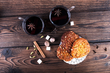 Decorated composition of mulled wine in glasses on wooden table