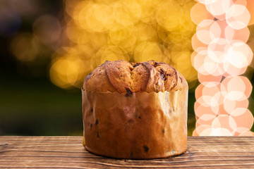 Delicious chocolate panettone with blurred christmas background