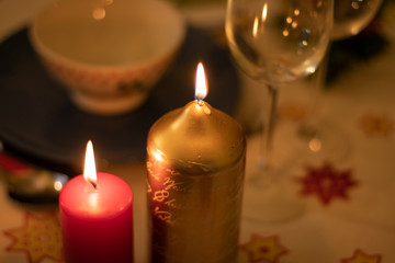 Detail of burning candles on a christmas table