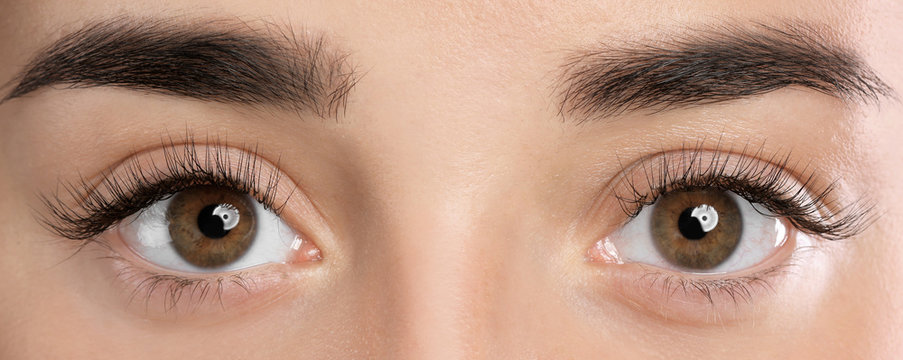 Closeup view of beautiful young woman with eyelash extensions
