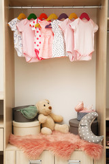 Wardrobe with cute baby clothes and toys