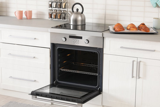 Open empty electric oven in modern kitchen